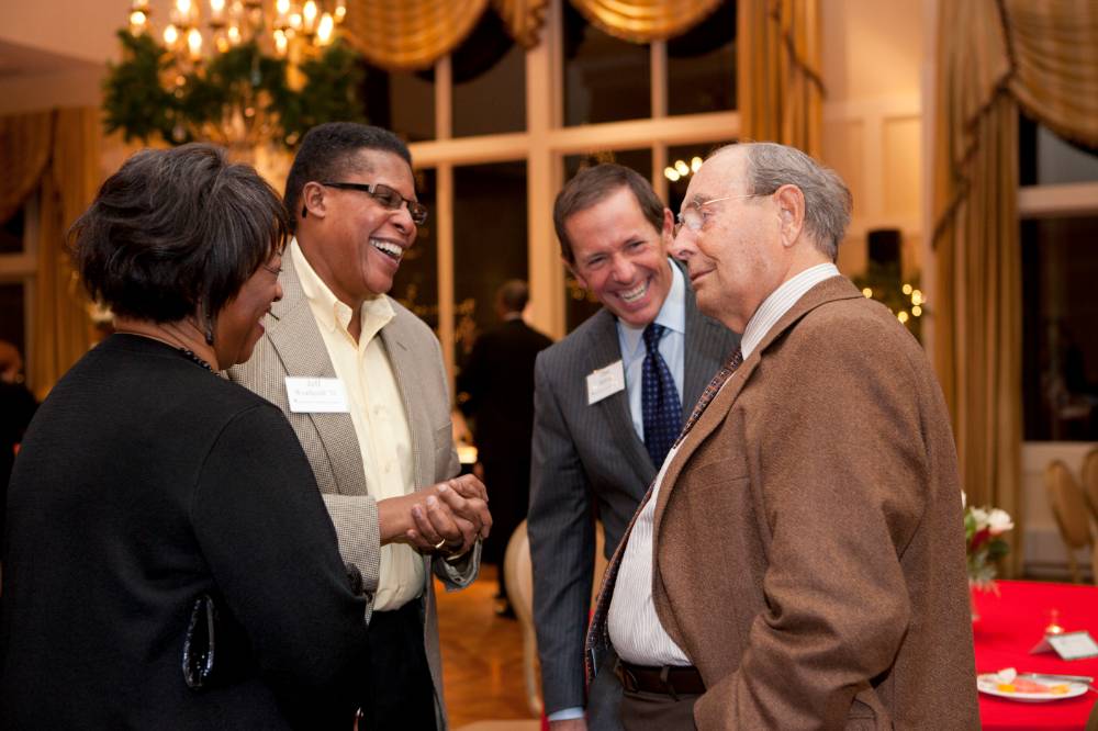 Richard and Dan DeVos talking with guests at an event.